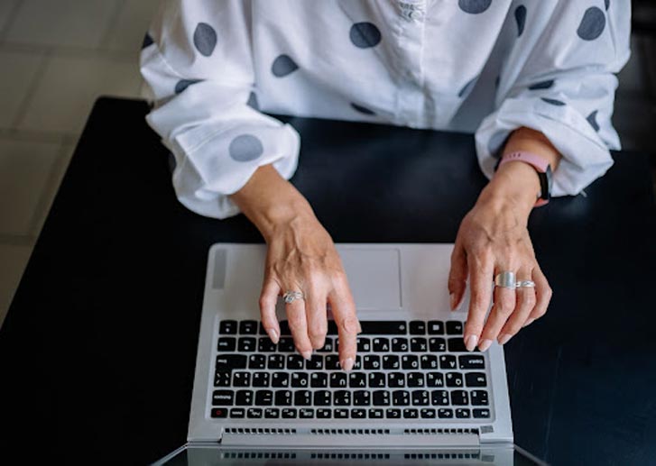 woman typing on her laptop